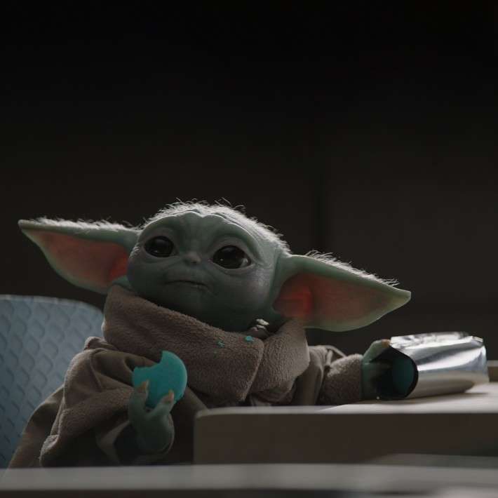Baby Yoda eating blue cookie