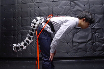 A demonstrator wearing an artificial robotic tail for humans