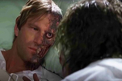 Two-Face (Aaron Eckhart) glares at The Joker in The Dark Knight (2008).