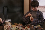 Harry Potter eats candy from a spread in Harry Potter and the Philosophers Stone (2001).