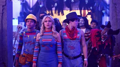 (l-r) Devon Evans (Bjorgvin Arnarson), Lexy Cross (Alyvia Alyn Lind), and Jake Wheeler (Zackary Arthur), all dressed as Chucky, walk past a man in a clown costume at a party in Chucky 304.