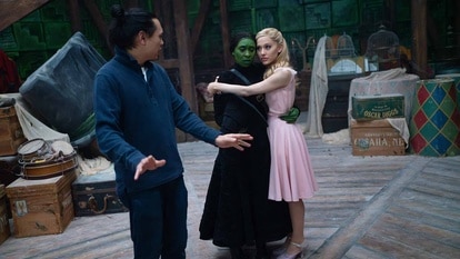 Jon M. Chu directs Elphaba (Cynthia Erivo) and Glinda (Ariana Grande) on the set of Wicked (2024).