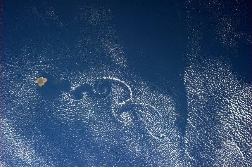Clouds swirl downwind of Isla Socorro, tracing complex von Kármán vortices. Credit: NASA