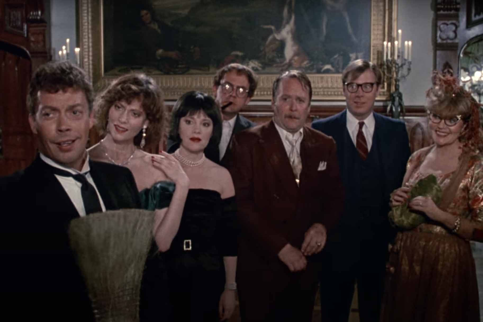 The cast wears formalwear and stares in Clue (1985).