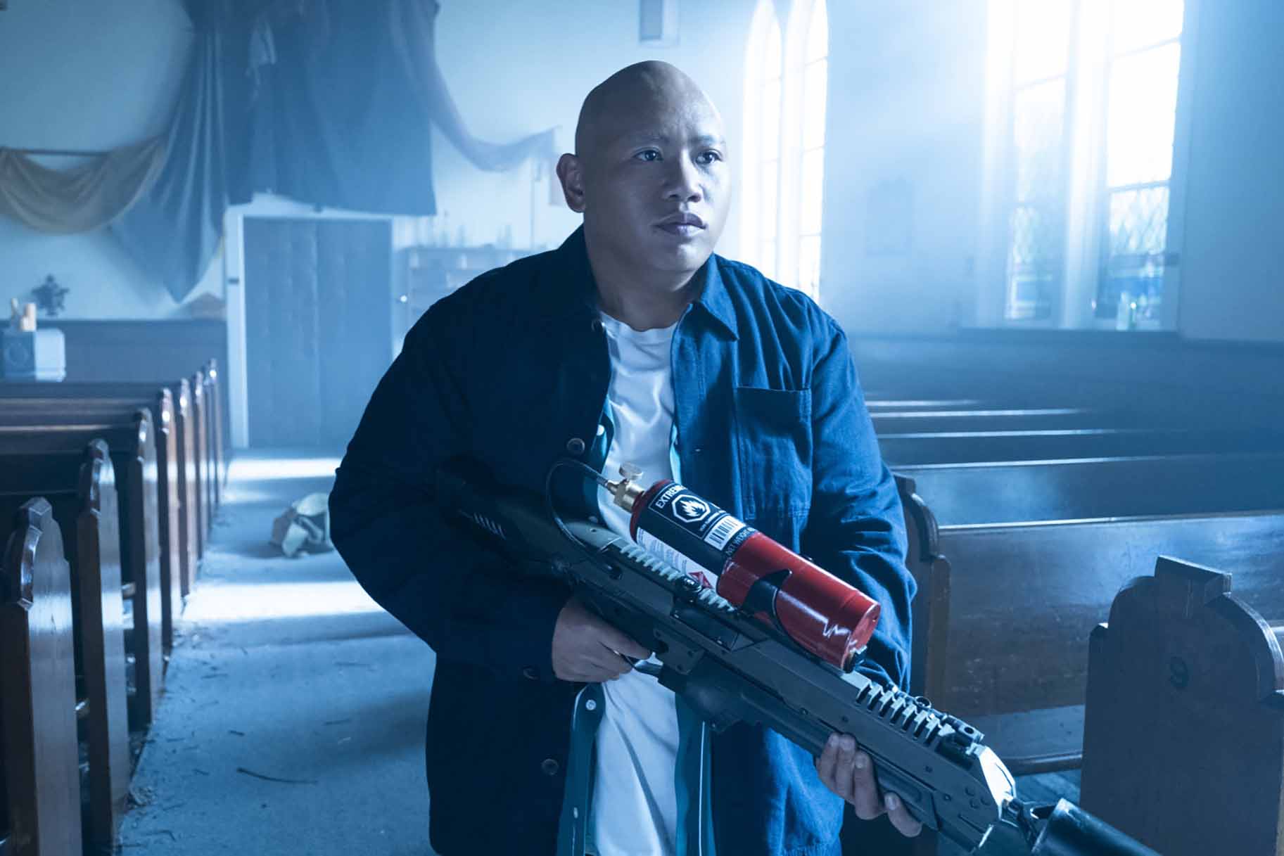 Reginald Andres (Jacob Batalon) holds a weapon in a church on Reginald the Vampire Episode 210.