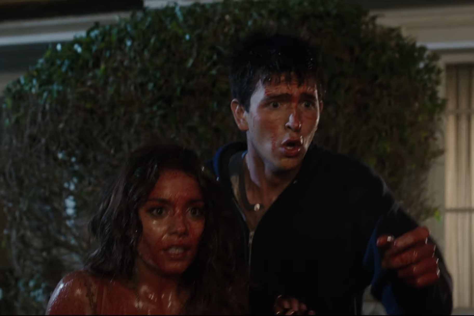 Lorelei (Vanessa Hudgens) and Dag (Nicholas Braun) are covered in blood in Freaks of Nature (2015).