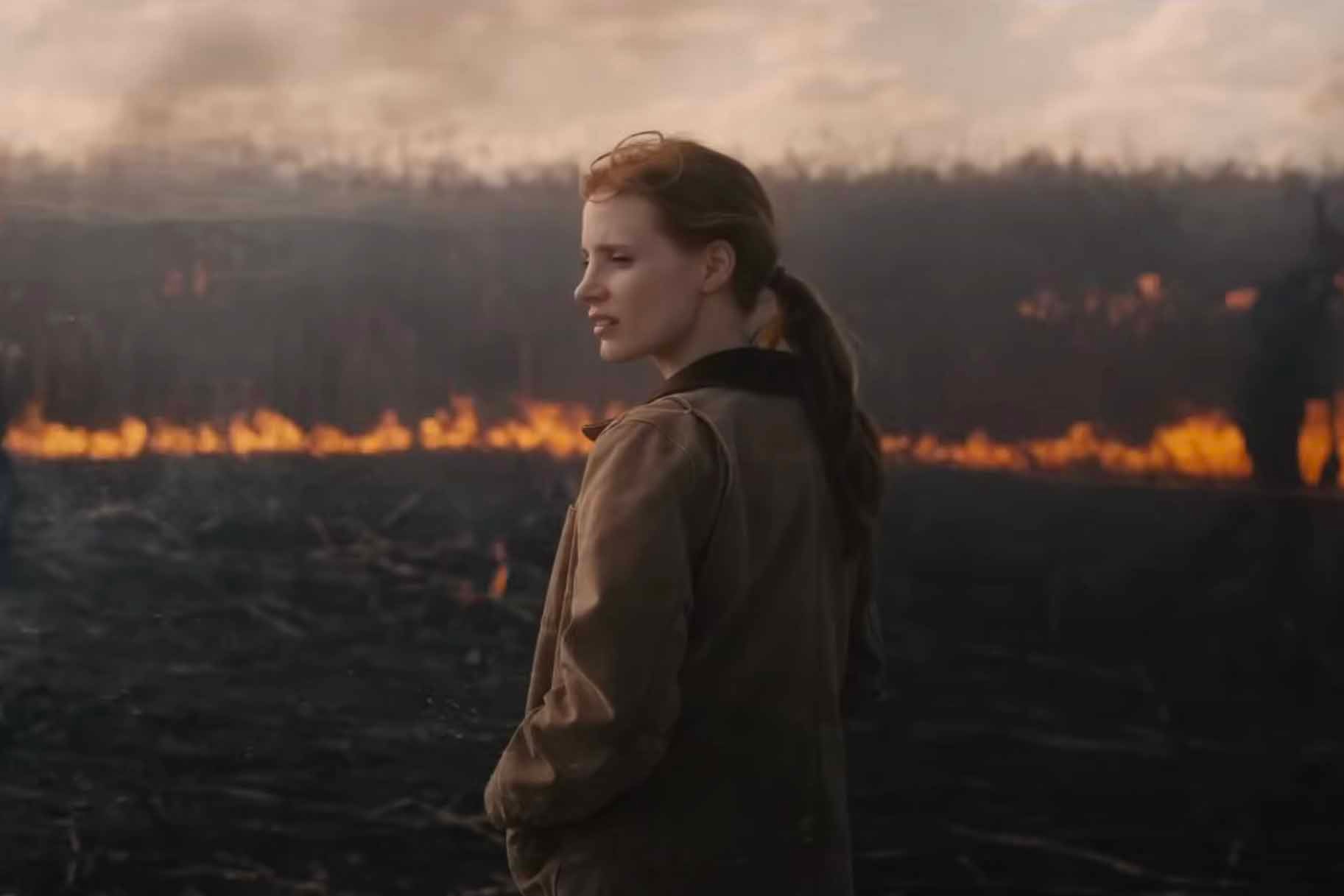 Murph (Jessica Chastain) stands in a scorching field in Interstellar (2014).