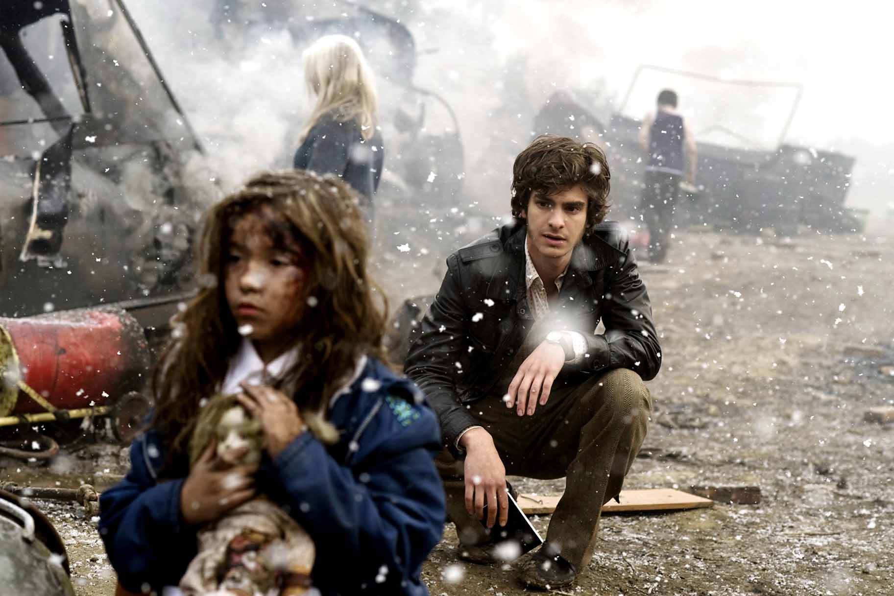 Eddie Dunford (Andrew Garfield) watches a child walk amongst wreckage in the snow in Red Riding: 1974 (2009).