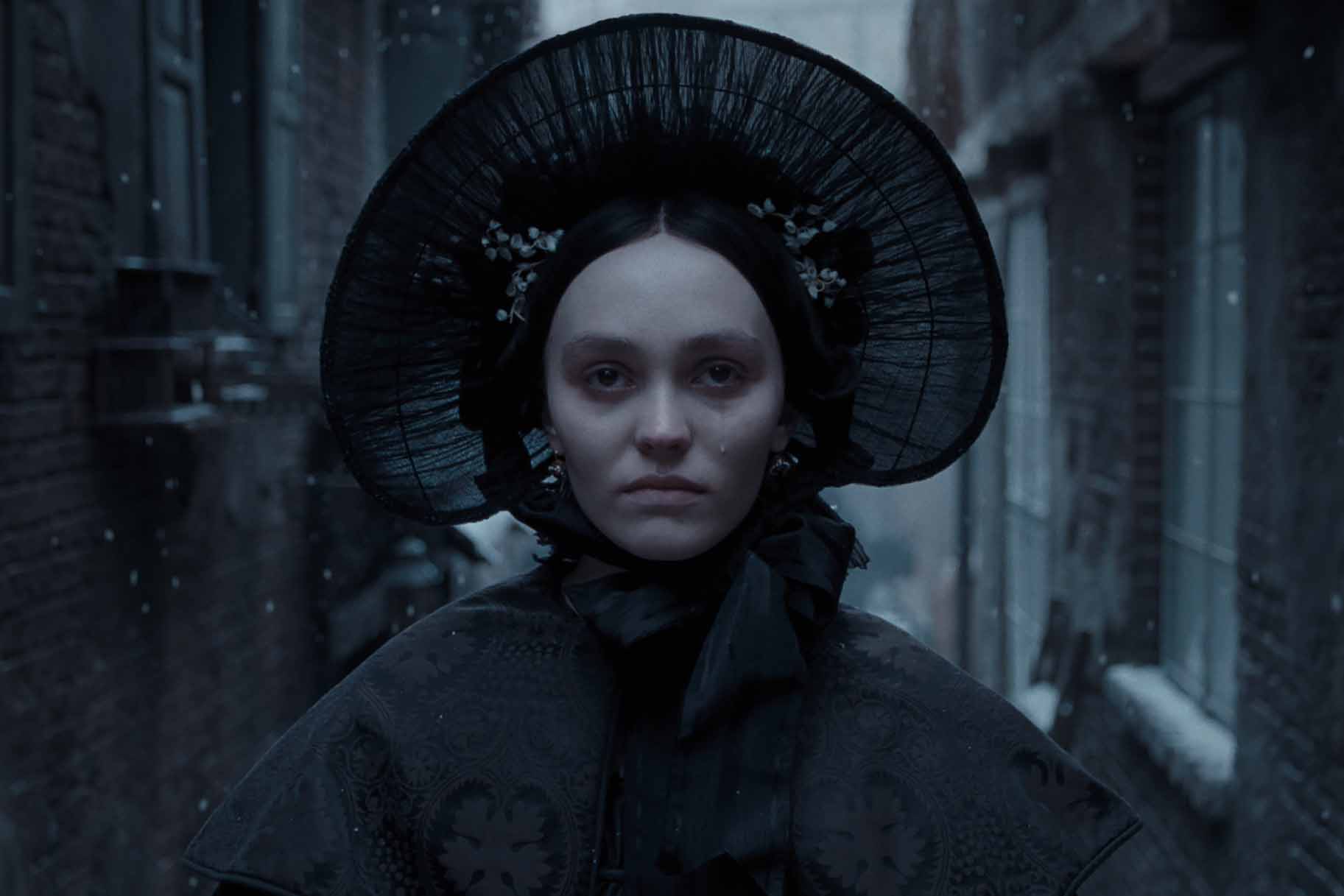 Ellen Hutter (Lily-Rose Depp) sheds a tear while wearing all black in Nosferatu (2024).