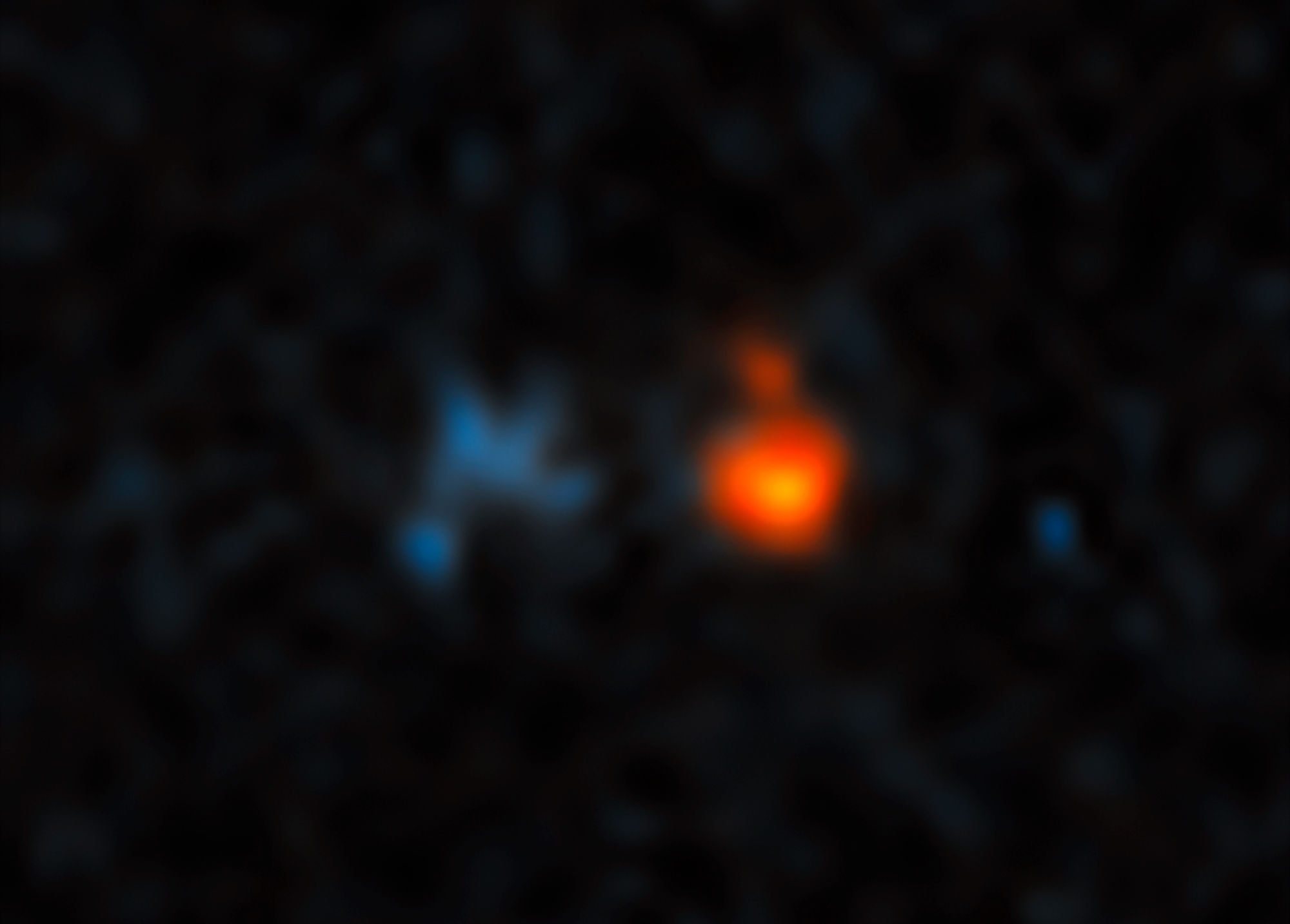 The quasar J043947.08+163415.7 (red) is extremely far away, and its light has been amplified by an intervening galaxy (blue) much closer to Earth. Credit: NASA, ESA, and X. Fan (University of Arizona)