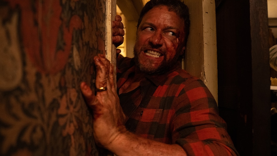 A bloody, angry Paddy (James McAvoy) squeezes through a door in Speak No Evil (2024).