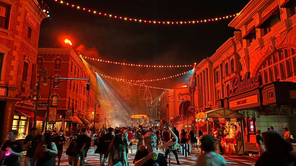 Guests walking around Halloween Horror Nights outdoors.