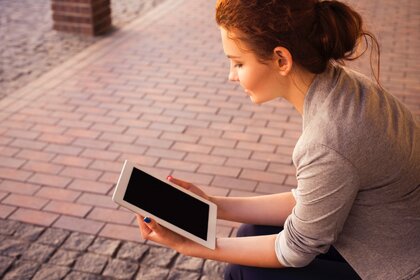 Young woman reading iPad