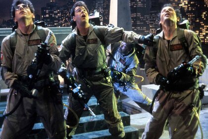 Egon Spengler (Harold Ramis), Ray Stantz (Dan Aykroyd), Winston Zeddemore (Ernie Hudson) (background), and Dr. Peter Venkman (Bill Murray) look up in their Ghostbuster uniforms in Ghostbusters (1984).