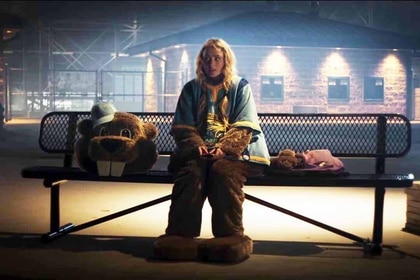 Millie Kessler (Kathryn Newton) sits on a bench in a mascot uniform with the beaver head next to her in Freaky (2020).