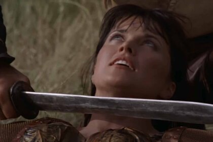 A sword is held up to Xena's (Lucy Lawless) throat in Hercules: The Legendary Journeys Episode 112
