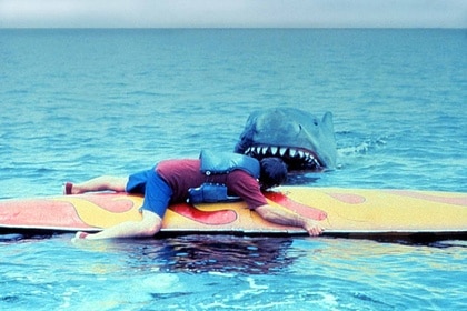 A shark approaches a surfer in Jaws 2 (1978).