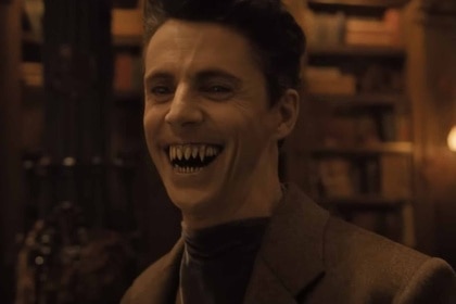 Dracula (Matthew Goode) smiles and shows his fangs in Abigail (2024).