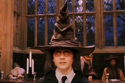 Harry Potter (Daniel Radcliffe) wears a sorting hat in Harry Potter and the Philosopher's Stone (2001).