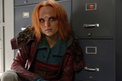 Irisa (Stephanie Leonidas) crouches near cabinets in Defiance Episode 111.