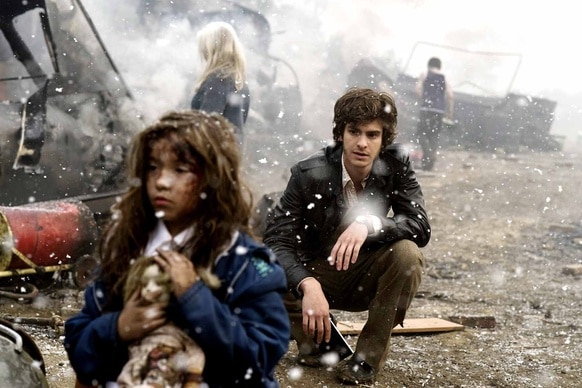 Eddie Dunford (Andrew Garfield) watches a child walk amongst wreckage in the snow in Red Riding: 1974 (2009).