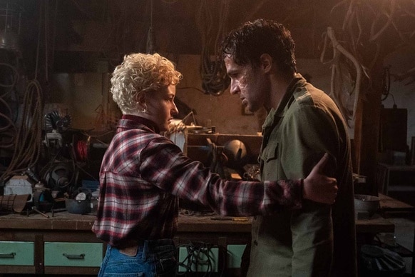 Charlotte (Julia Garner) tends to a disfigured Blake (Christopher Abbott) in Wolf Man (2024).