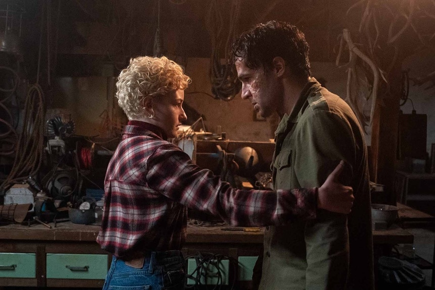 Charlotte (Julia Garner) tends to a disfigured Blake (Christopher Abbott) in Wolf Man (2024).