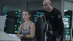 Eva Markovic (Tiana Upcheva) and Felix Strickland (Pavle Jerinic) look at a computer on The Ark Episode 211.