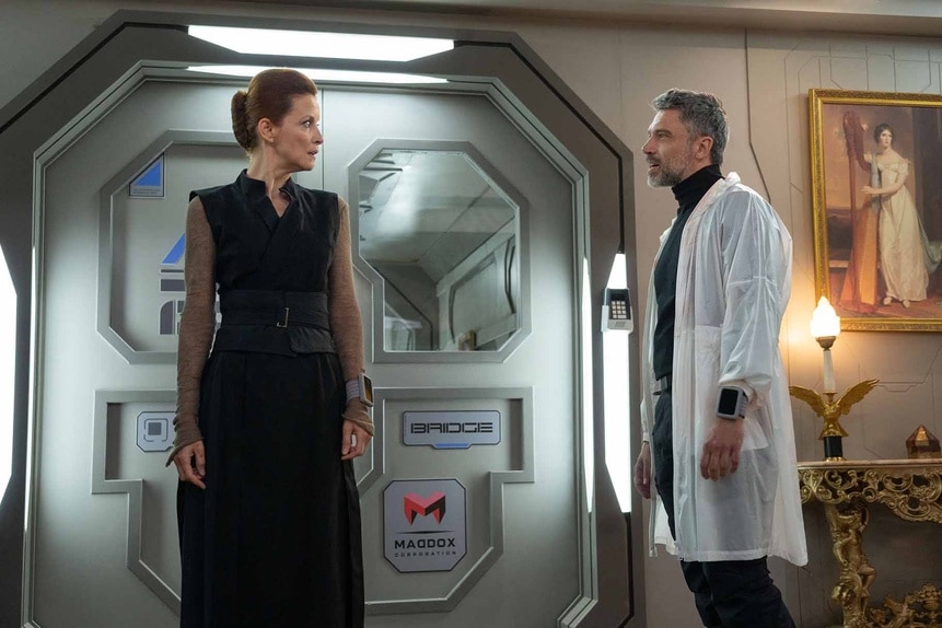 Evelyn Maddox (Jelena Stupljanin) and Dr. Marsh (Jadran Malkovich) look at each other on The Ark Season 2.