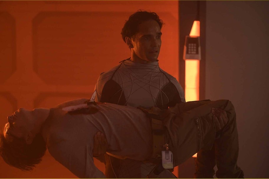 Nup 203841 00629aLT. Spencer Lane (Reece Ritchie) holds Angus Medford's (Ryan Adams) limp body on The Ark Season 2.