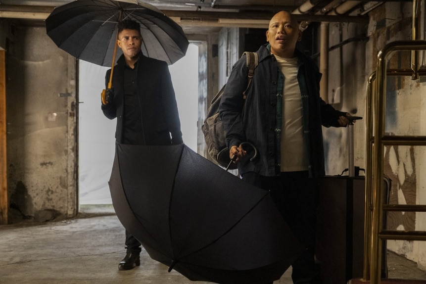 Maurice Miller (Mandela Van Peebles) and Reginald Andres (Jacob Batalon) hold umbrellas on Reginald The Vampire Episode 206.