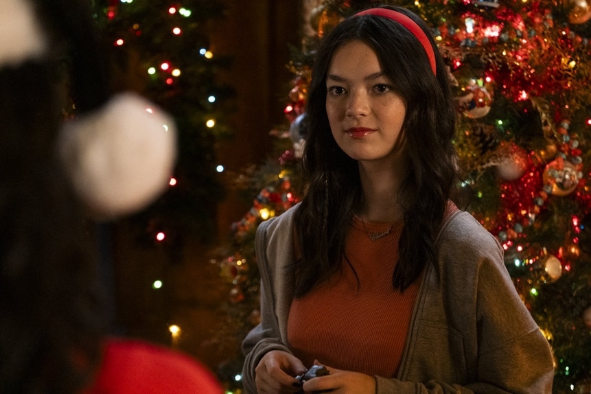 Claire (Thailey Roberge) stands in front of a Christmas tree on Reginald the Vampire Episode 207.
