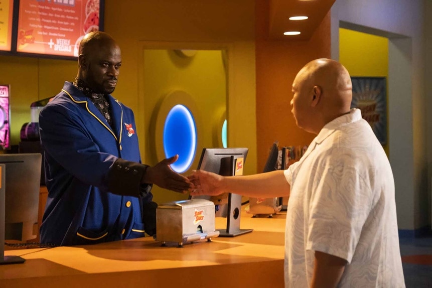 Reginald Andres (Jacob Batalon) and Bolestro (Garfield Wilson) shake hands over a snack counter in Reginald the Vampire Episode 209.