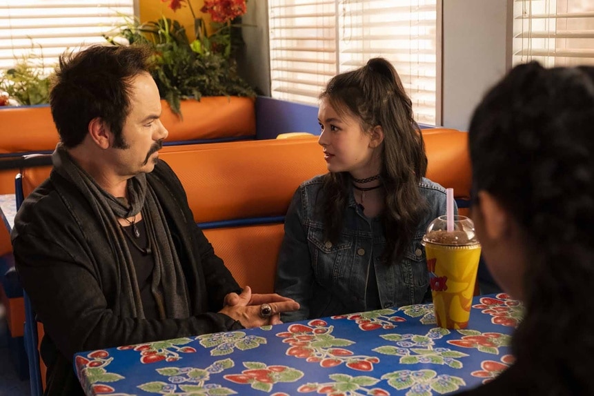 Altus (Jed Rees) and Claire (Thailey Roberge) chat in a booth in Reginald the Vampire Episode 209.