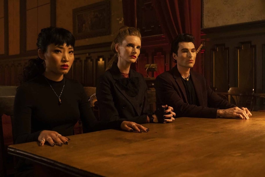 Nikki (Christin Park), Penelope (Georgia Waters), and LeBron (Sean Yves Lessard) sit at a table in Reginald the Vampire Episode 209.