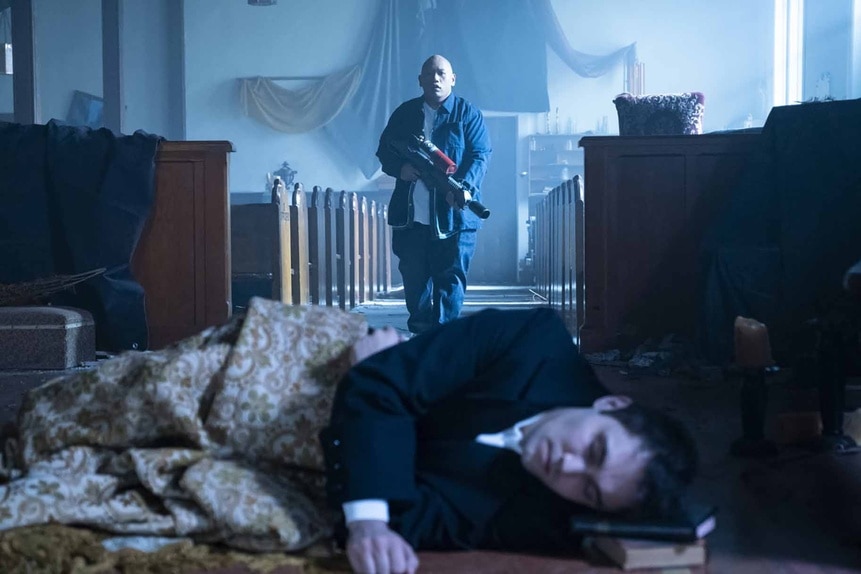 Reginald Andres (Jacob Batalon) holds a weapon and approaches a sleeping Uriel (Max Montesi) on Reginald the Vampire Episode 210.