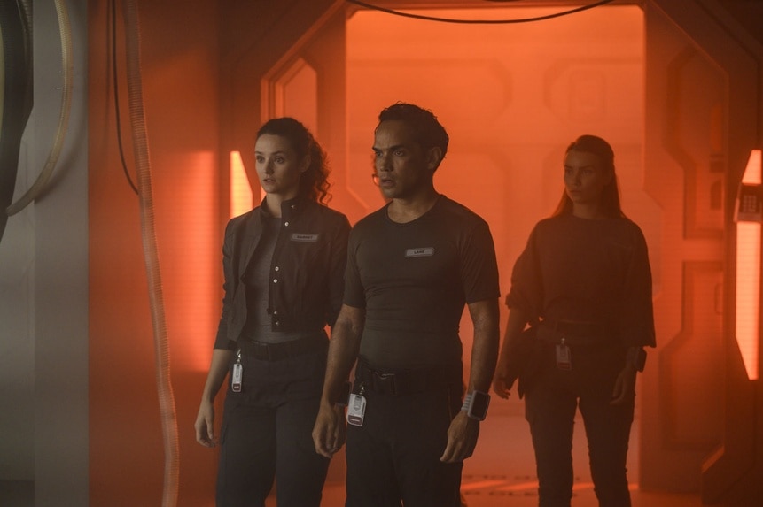 Lt. Sharon Garnet (Christie Burke), Lt. Spencer Lane (Reece Ritchie), and Eva Markovic (Tiana Upcheva) walk through warm light on The Ark Episode 204.