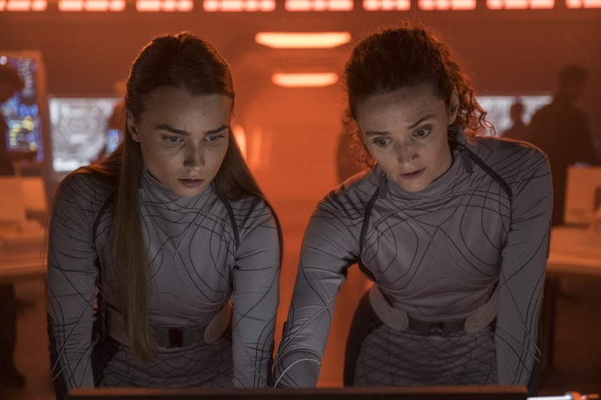 Eva Markovic (Tiana Upcheva) and Lt. Sharon Garnet (Christie Burke) wear matching grey uniforms in The Ark Episode 205.