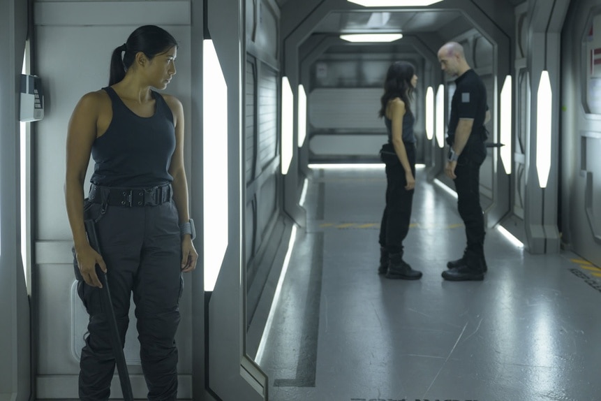 Kimi (Diana Bermudez) spies on Jelena Griff (Tamara Radovanovic) and Felix Strickland (Pavle Jerinic) in The Ark Episode 205.