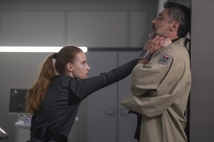 Kelly Fowler (Samantha Glassner) chokes Dr. Marsh (Jadran Malkovich) against a wall in The Ark Episode 205.