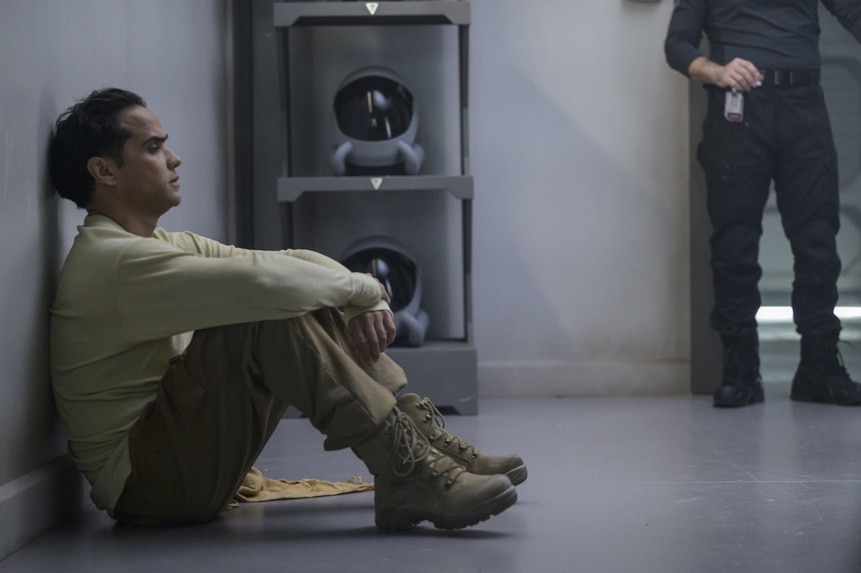 Lt. Spencer Lane (Reece Ritchie) leans on a cell wall on The Ark Season Episode 207.