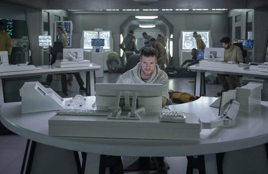 Milos Warren (Kieran Mortell) works in a computer lab on The Ark Episode 208.