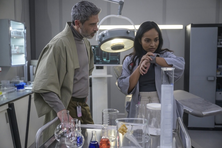 Dr. Marsh (Jadran Malkovich) watches Dr. Sanjivni Kabir (Shalini Peiris) look at her wrist monitor on The Ark Episode 208.