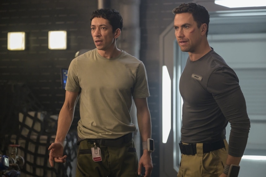 Sasha Novak (Miloš Cvetković) and Lt. James Brice (Richard Fleeshman) appear concerned on The Ark Episode 208.