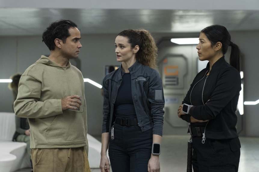 Ian (Reece Ritchie), Lt. Sharon Garnet (Christie Burke), and Kimi (Diana Bermudez) stand and chat on The Ark Episode 209.