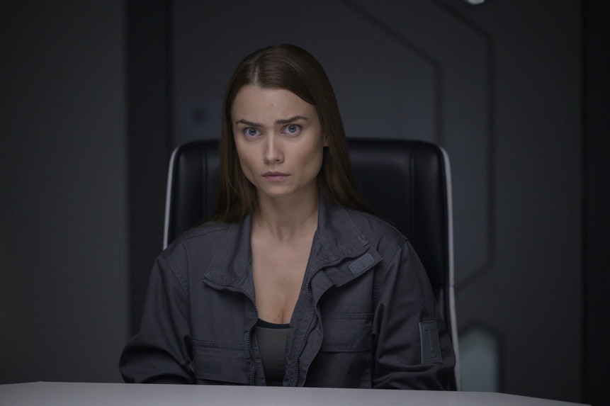 Eva Markovic (Tiana Upcheva) frowns in a chair in The Ark Season 2 Episode 9 "Cycle of Violence".