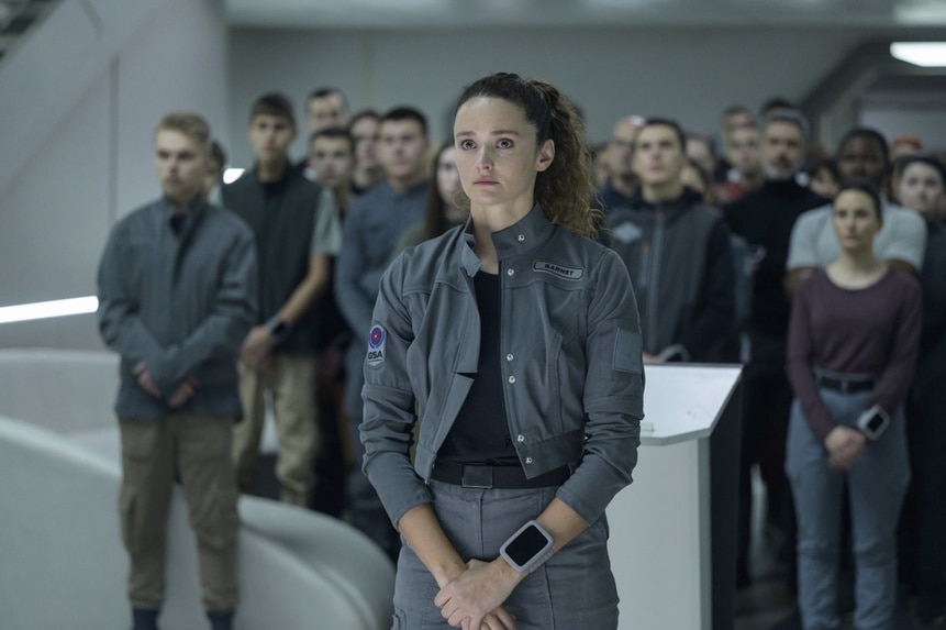 Lt. Sharon Garnet (Christie Burke) stands with a crowd of people behind her in The Ark Episode 210.