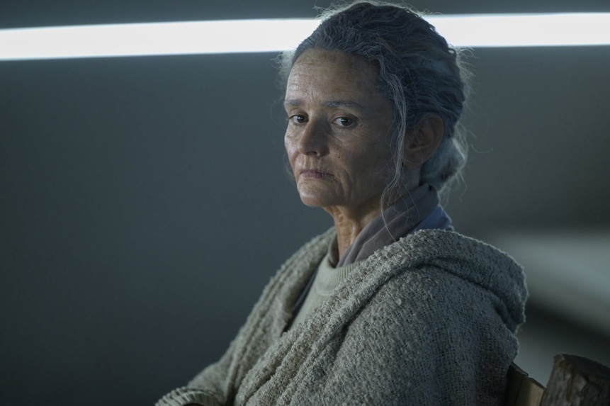 An elderly Lt. Sharon Garnet (Christie Burke) sits in The Ark Episode 210.