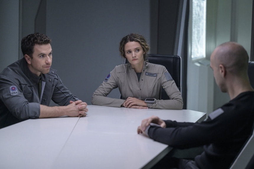 Lt. James Brice (Richard Fleeshman) and Lt. Sharon Garnet (Christie Burke) discusses at a table on The Ark Episode 211.