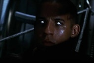 Riddick (Vin Diesel)'s eyes glow white in the dark in Pitch Black (2000).